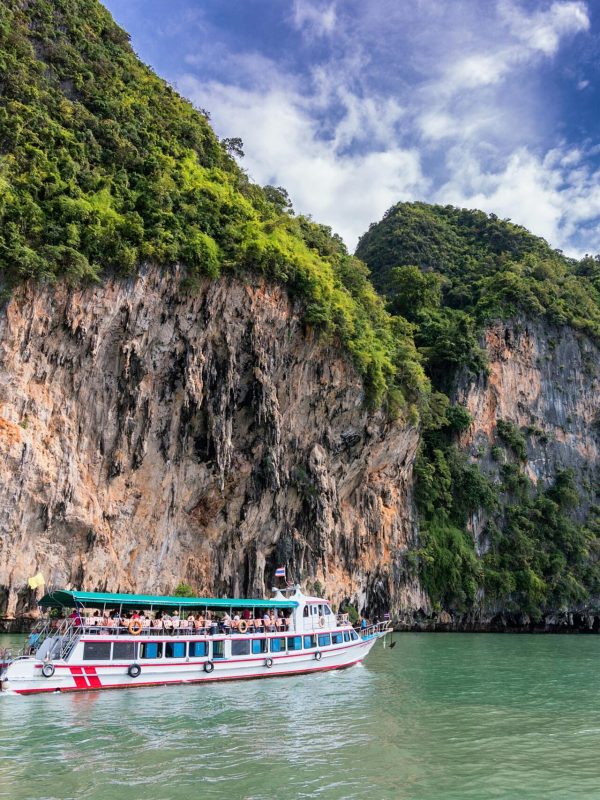 pexels-photo-358229-358229 A boat cruise offers breathtaking views of lush cliffs under a bright blue sky.
